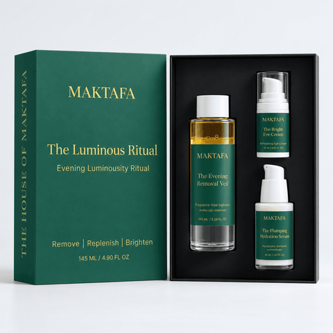 The Luminous Ritual: three products fitted inside an open black presentation box, beside its emerald lid.