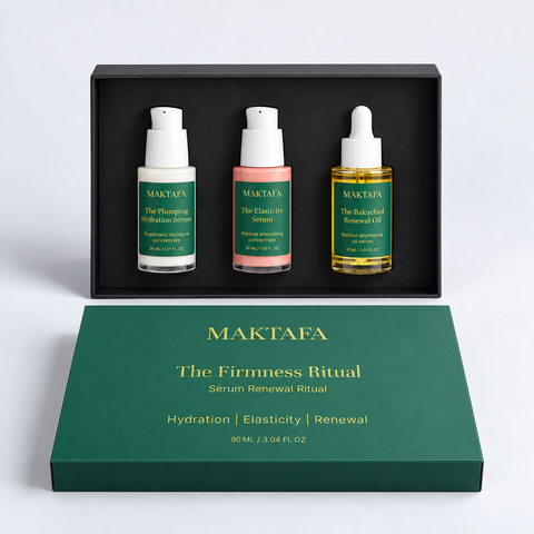 The Firmness Ritual: three products fitted inside an open black presentation box, beside its emerald lid.