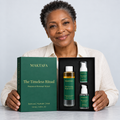 A person presenting the open The Timeless Ritual box with all three products visible.