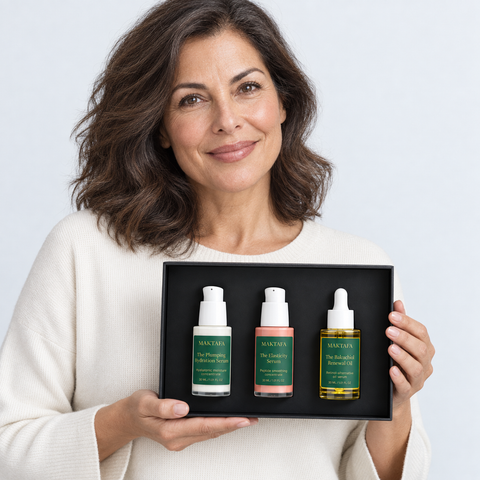 A person presenting the open The Firmness Ritual box with all three products visible.