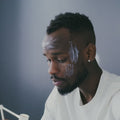 Illustrative video of a person massaging cream across the forehead.