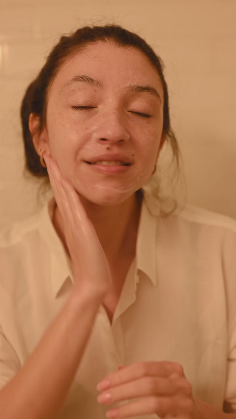 Illustrative video of a person massaging skincare over the face.